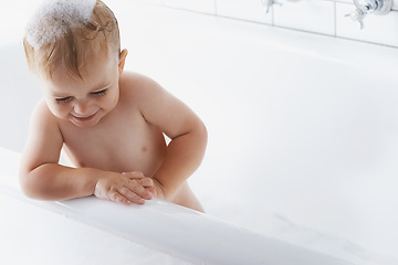 Image showing Happy baby in bath with soap, bubbles and cleaning on mockup in morning routine for hygiene, wellness and care in home. Toddler washing in foam with smile, relax and laughing child in tub in bathroom