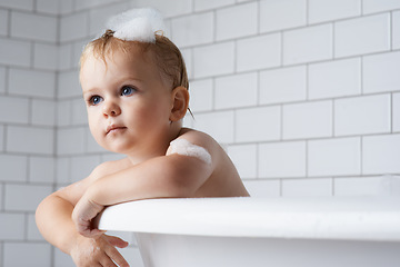 Image showing Boy, baby and child in bath of bubbles, tub and cleaning with water for skincare, morning routine and wellness at home. Toddler kid, thinking and washing hair with soap, foam and hygiene in bathroom