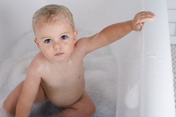 Image showing Portrait, baby and kid in bath, tub and cleaning with water for soft skincare, morning routine and healthy wellness at home. Cute toddler, boy child and washing for hygiene, soap and foam in bathroom