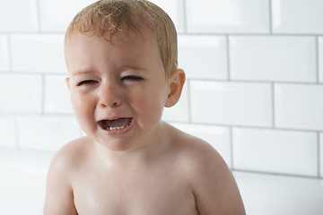 Image showing Sad, crying and baby boy at home, unhappy and distress and naughty childhood personality. Problem, emotional and frustrated young kid, bathroom and toddler with development, wet and vulnerable