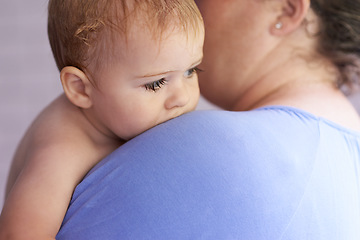 Image showing Mom, comfort and holding baby with calm, sleepy or tired in home with support and care. Mother, love and carry child in arms bonding with kindness in bedroom and infant with trust in mama and family