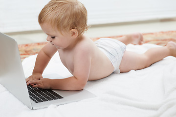 Image showing Baby, playing and learning on laptop in home on bed with online games for education. Child, typing and relax with cartoon, movies or development of knowledge of technology with elearning for growth