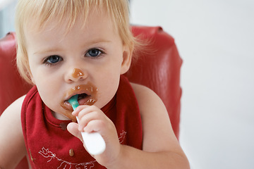 Image showing Hungry, portrait and baby eating porridge for health, nutrition or child development at home. Food, cute and girl toddler or kid enjoying organic puree meal for lunch or dinner in high chair at house