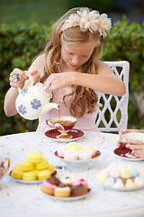 Image showing Girl, child and pouring tea in garden with party for birthday, celebration and playing outdoor in home. Person, kid and porcelain cup in backyard of house with dress up, beverage and role play fun