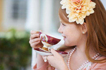 Image showing Girl, child and happy with tea in garden with party for birthday, celebration and playing outdoor in home. Person, kid and porcelain cup in backyard of house with dress up, beverage and role play fun