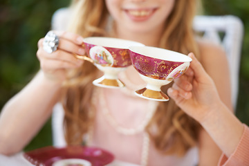 Image showing Hands, tea cup and cheers, party and girl children playing with care, celebration and fun in backyard. Closeup of toast, beverage or drink with friends outdoor in garden for game or birthday