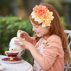 Image showing Girl, child and tea party or outdoor play for fantasy fancy game for snack, birthday or beverage. Kid, youth and smile in backyard with cup for warm drink fr summer dress up, flowers or preschool