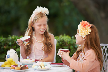Image showing Tea, party and girl children are happy outdoor, playing with fine china for celebration and fun in backyard. Relax, spring and kids in garden together, friends with beverage or drink for bonding