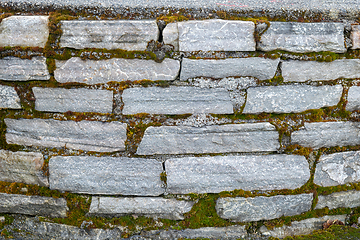 Image showing Close-Up View of an Old Stone Wall With Green Moss Growth in Day