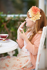 Image showing Girl, child and tea party or dress up outdoor for fun fantasy game, play or make believe. Female person, flower crown and happy in nature backyard for fancy beverage drinking in garden, joy or summer