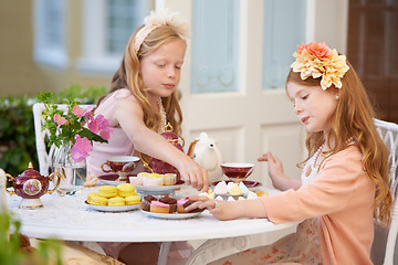 Image showing Children, friends and tea in garden for party at birthday for snack for dress up game, fantasy or play. Female people, siblings and pot for hot drink in backyard for summer dessert, lunch or macarons