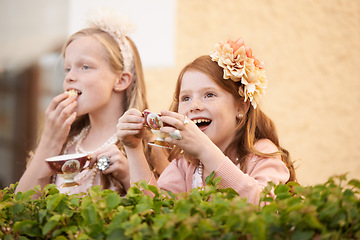 Image showing Girl, friends and tea party in backyard for happy dress up game, fantasy or playing. Female people, siblings and hot drink in garden nature for summer bonding fun or kid lunch, birthday or beverage