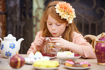 Image showing Girl, child and drinking tea in garden with party for birthday, celebration and playing outdoor in home. Person, kid and porcelain cup in backyard of house with dress up, beverage and role play fun