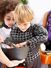 Image showing Children, halloween candy and group of friends in neighborhood together for trick or treat tradition. Kids, youth and celebration with young boys collecting sweets for spooky holiday or vacation