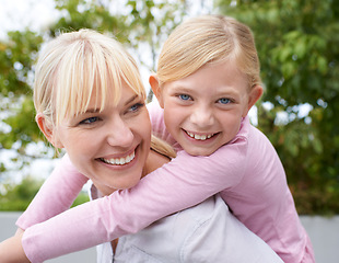 Image showing Nature, piggyback and portrait of mother with kid playing in an outdoor park, garden or field. Love, smile and happy young mom having fun, bonding and carrying cute girl child outside in summer.