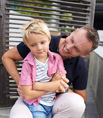 Image showing Laughing, happy and father tickling child for bonding together in backyard at family home. Smile, annoyed and dad playing and having fun with bored boy kid by wood gate for quality time outdoor house