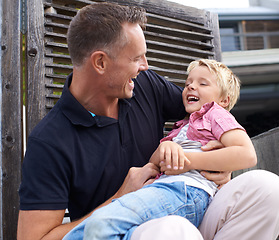 Image showing Laughing, happy and father tickling child for bonding together in backyard at family home. Smile, funny and dad playing and having fun with boy kid by wood gate for quality time outdoor a house.