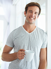 Image showing Man, coffee cup and portrait by window in morning with smile, relax or espresso with drink, choice or beverage in home. Person, tea and happy on holiday in house, apartment and latte to start day