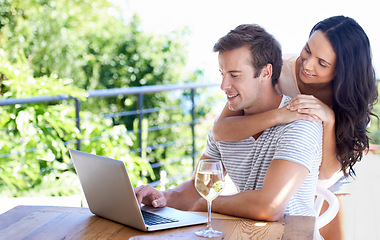 Image showing Happy couple, love and outdoor by laptop on table, champagne and positive as freelancer in typing proposal. Man, woman and smile by pc in online business, wellness and hugging entrepreneur by drink