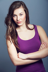 Image showing Woman, confidence and makeup in studio portrait, cosmetics and beauty on gray background. Female person, attitude and pride for hair and cool fashion, arms crossed and wellness or face by backdrop