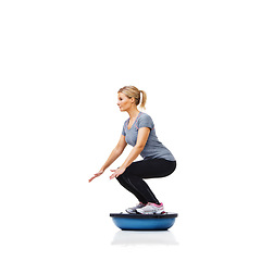 Image showing Woman, studio and squat with workout, ball or balance for legs, muscle development or profile by white background. Person, exercise and training for strong healthy body for vision, wellness or health