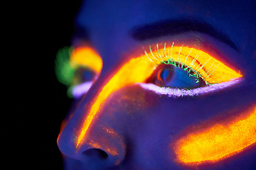 Image showing Eyes, art and creative with neon woman on black background in studio for bright vision or fantasy. Face, future and psychedelic with model in dark for galaxy or universe paint on glowing skin closeup