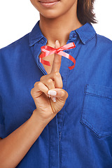 Image showing Red, ribbon and bow on finger for reminder of event, commitment or sign remember a task. Attention, symbol and icon on hand to notice date of appointment or helping to alert memory of person