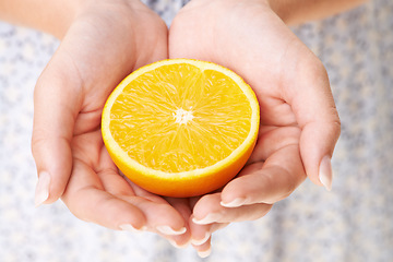 Image showing Health, hands and closeup of woman with orange in studio for detox, vegan diet and fresh ingredient. Wellness, nutrition and zoom of female model with organic fruit or produce for vitamin c benefits.