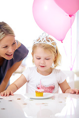 Image showing Birthday, girl and mother with cupcake, candle and balloons for party, celebration and fun. Toddler with princess tiara, cake or dessert and woman with child at family home for milestone and event