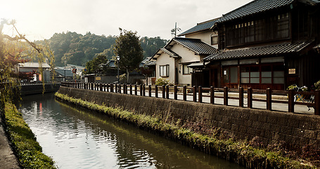 Image showing Houses, building and canal with trees in Japan of architecture, structure or natural scenery in neighborhood. Japanese village, home or outdoor street or stream of quiet or peaceful town in Tokyo