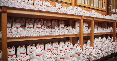 Image showing Japan, traditional and neko maneki or group in shop for good luck cat, fortune or culture. Sculpture figure, gotokuji and store for travel destination in Tokyo for local history, spiritual or gift