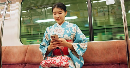 Image showing Woman, japan and train with kimono, phone and travel with public transport, metro bullet in city. Person, journey or traditional clothes in motion blur on weekend or commute in tokyo on adventure