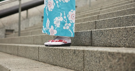 Image showing Feet, stairs and person in Japanese kimono for travel, tourism or Tokyo sightseeing closeup. Sandals, steps and culture with tourist outdoor in clothes for tradition, vacation or holiday adventure