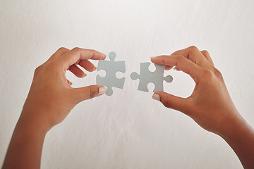 Image showing Hands, studio or puzzle for problem solving, solution or innovation on white background. Development project, mission or closeup of person for answer, jigsaw strategy or creative brainstorming plan