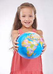 Image showing Kid, portrait and globe in studio with world, planets and city for education, geography and happy. Student, girl child and travel map with smile for earth day support or lesson on white background