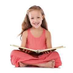 Image showing Portrait, happy and child reading books in studio for learning, language development and studying knowledge on white background. Young girl, kid and sitting on floor for story, education and literacy