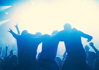 Image showing Nightclub, people and audience with silhouette or lights for party, concert or rave festival with dance and dj. Disco, psychedelic event and performance with entertainment, crowd and hand gesture