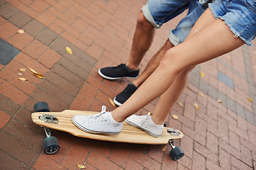 Image showing Skateboard ride, legs and couple of friends teaching partner sports skills, exercise lesson or training on urban ground. Skate, cardio fitness or shoes of people helping, coaching and support balance