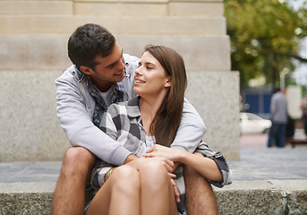 Image showing City, eye contact and happy couple hug together, relax and enjoy outdoor date with care, support and romance. Urban steps, connection and people smile for relationship security, soulmate or devotion