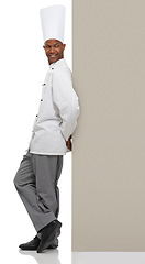 Image showing Happy man, chef and poster menu in studio isolated on a white background mockup space. Smile, cooking and African person on billboard for advertising, marketing sign and restaurant promotion banner