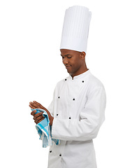 Image showing Chef, man and wipe hands with towel in studio isolated on a white background. African person, cooking professional or cleaning in preparation for catering service, restaurant work or hygiene of baker