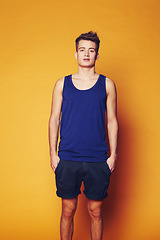 Image showing Fashion, portrait and man in studio with trendy, cool or summer clothes on orange background. Style, attitude or serious male model with confidence, personality or casual, streetwear or outfit choice