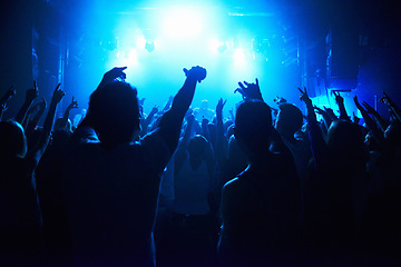 Image showing Nightclub, people and crowd with energy and lights for party, concert or rave festival with spotlight and dancing. Disco, psychedelic event and performance with entertainment, audience and rear view