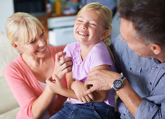 Image showing Girl, parents and tickle for fun at home, security and love in childhood or happiness. Family, daughter and child playing games on vacation, smiling and connection or care in relationship on holiday