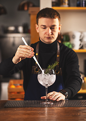 Image showing Expert barman is making cocktail