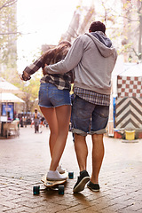 Image showing Skateboard, ride and couple of friends teaching partner sports skills, exercise lesson or training in urban Paris. Skate, back and learning skateboarder helping, coaching and support balance of rider