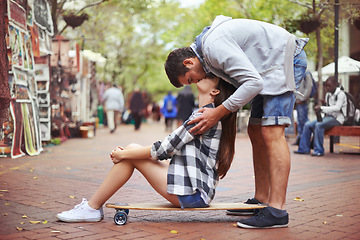 Image showing Couple, sitting on skateboard and kiss in city, happy and romantic partner, learn together and relationship. Cape town, fun and hobby with boyfriend and girlfriend in street, love and dating