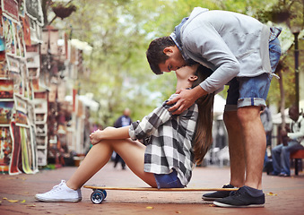 Image showing Couple, sitting on skateboard and kiss in city, happy and romantic partner, learn together and relationship. Cape town, fun and hobby with boyfriend and girlfriend in street, love and dating