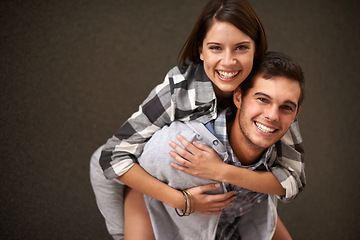 Image showing Studio, hug and portrait of happy couple, piggyback ride and having playful fun together on brown background. Wellness, embrace and young silly man, woman or people smile for goofy game