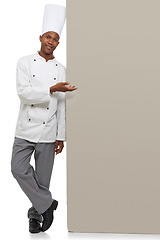 Image showing Portrait, poster and black man chef with hand pointing in studio for checklist, menu or space on white background. Bakery, presentation or baker face with food tips billboard, guide or steps mock up